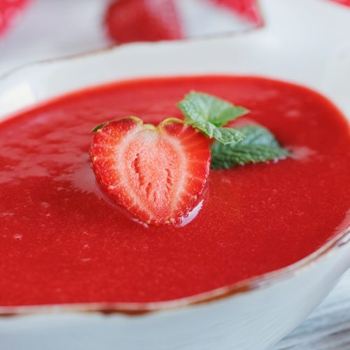 A bowl of strawberry soup gazpacho with mint