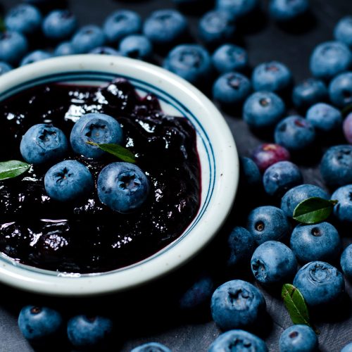 Blueberries and blueberry jam in a small bowl