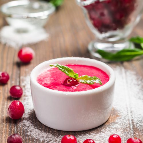 cranberry mousse with semolina on dark wooden background