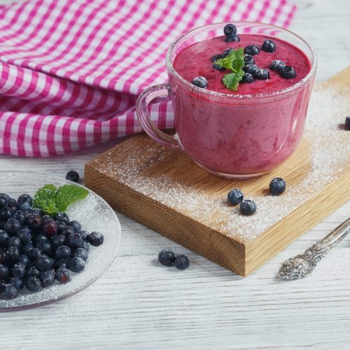 Delicious bilberry smoothie with fresh berries. Fresh yogurt with bilberry. Healthy breakfast.